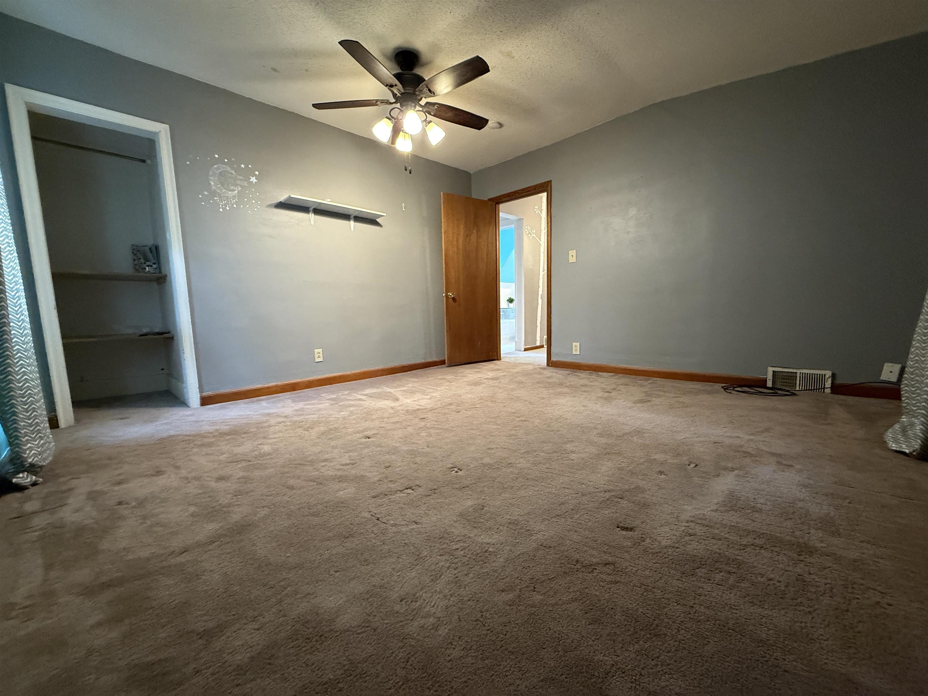 809 16th Street North Virginia, MN 55792 - Photo 33 of 44 Unfurnished bedroom featuring carpet, a textured ceiling, and ceiling fan