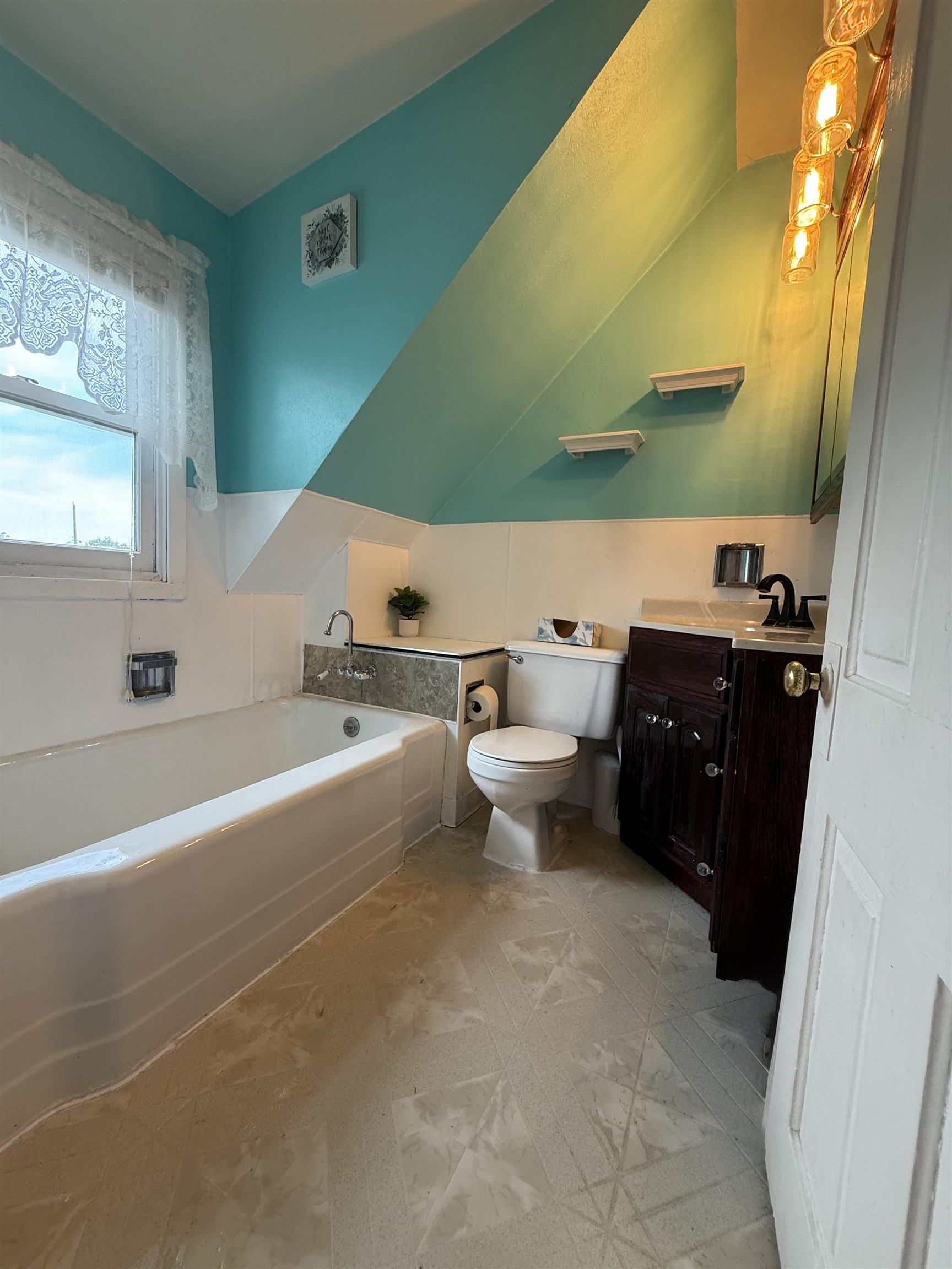 809 16th Street North Virginia, MN 55792 - Photo 36 of 44 Bathroom featuring a bath, vanity, and vaulted ceiling