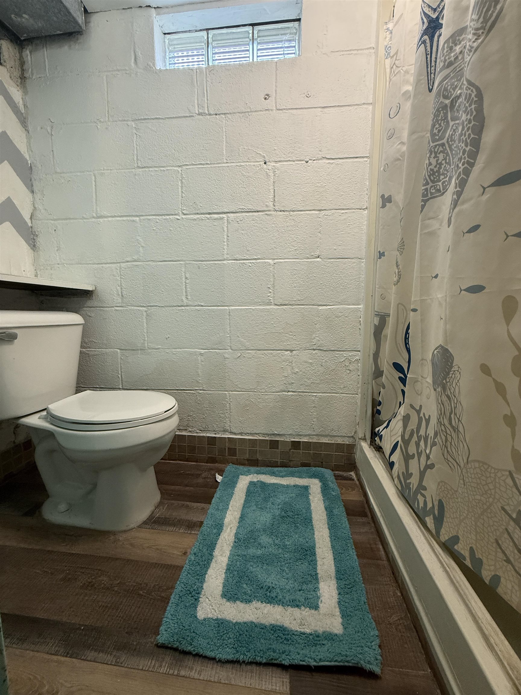 809 16th Street North Virginia, MN 55792 - Photo 38 of 44 Bathroom featuring a shower with shower curtain and wood finished floors