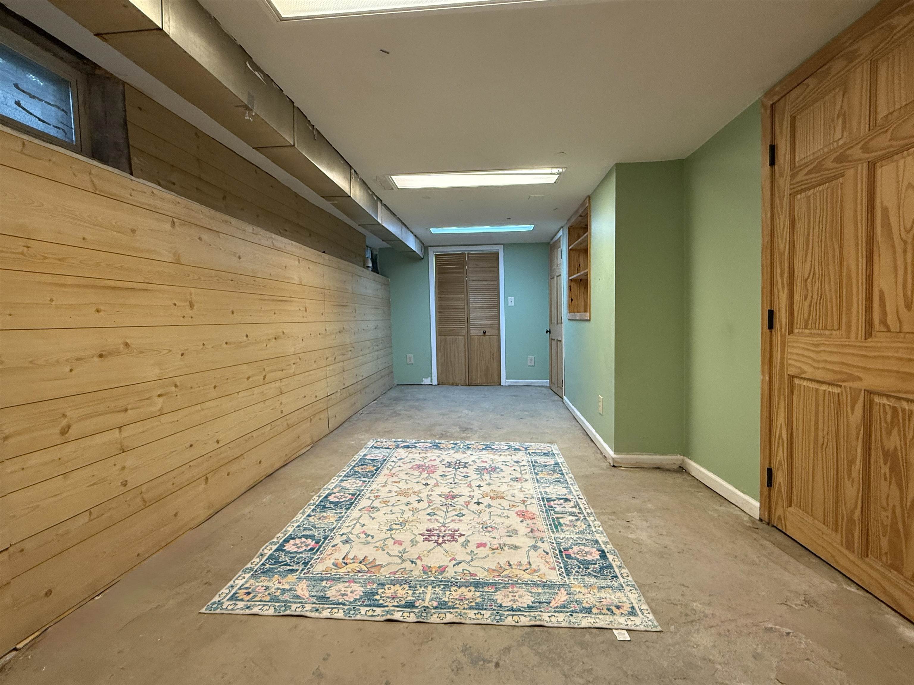 809 16th Street North Virginia, MN 55792 - Photo 39 of 44 Hallway with concrete flooring and wood walls
