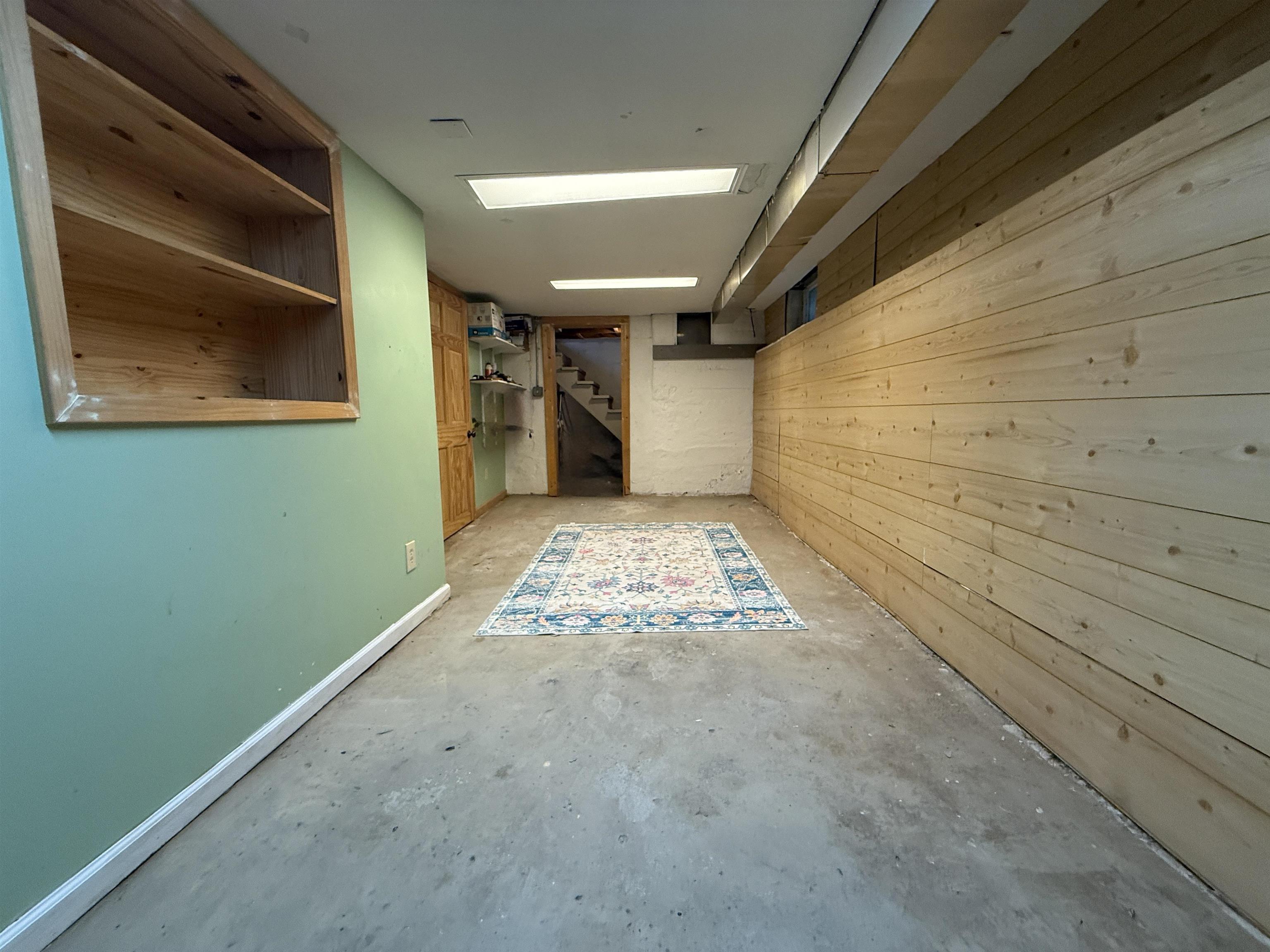 809 16th Street North Virginia, MN 55792 - Photo 40 of 44 Finished below grade area featuring stairs and wooden walls