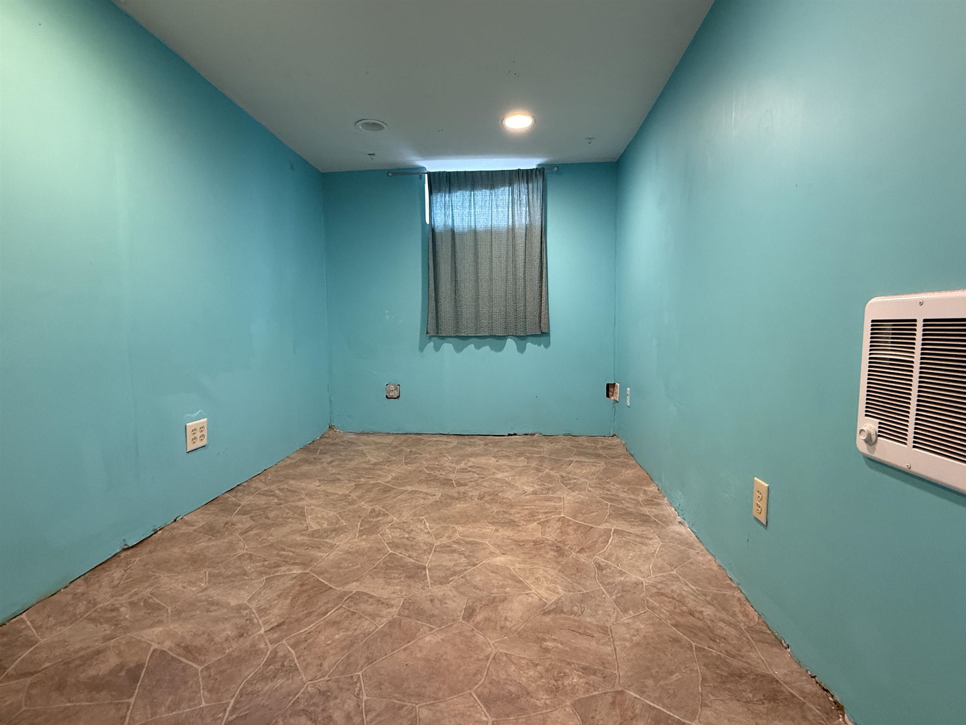 809 16th Street North Virginia, MN 55792 - Photo 41 of 44 Empty room with stone finish flooring and heating unit