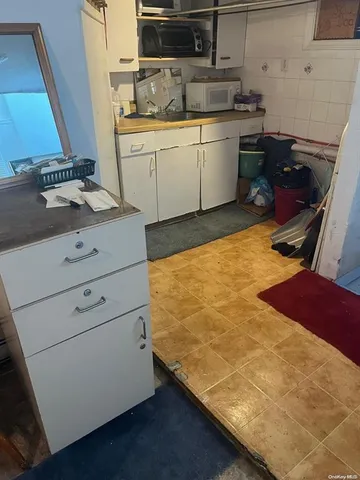 a kitchen with a sink stove and cabinets