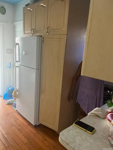 a view of storage and utility room with wooden floor