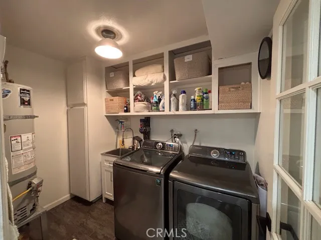 a utility room with sink dryer and washer