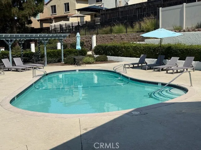 an outdoor space with pool and furniture