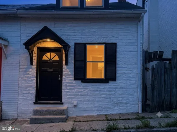 a front view of a house with a brick wall