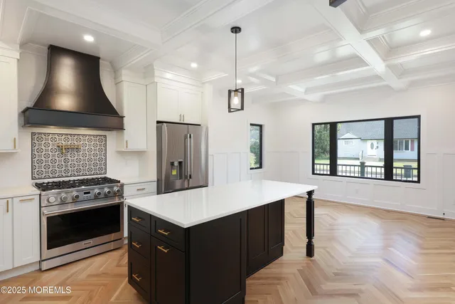 a kitchen with stove cabinets and refrigerator