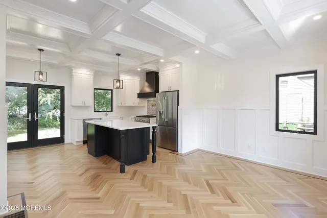 a large room with a large window and stainless steel appliances
