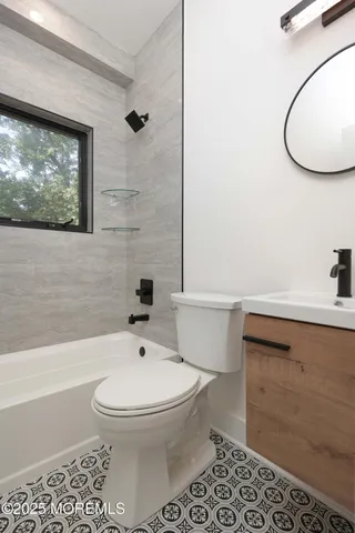 a bathroom with a toilet a sink and mirror