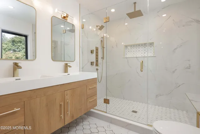 a bathroom with a shower sink and mirror