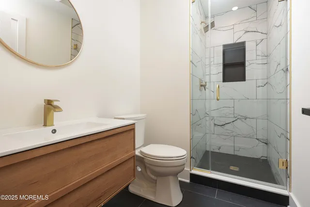 a bathroom with a sink a toilet and shower