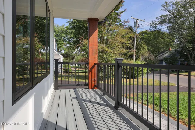 a view of a balcony with wooden floor