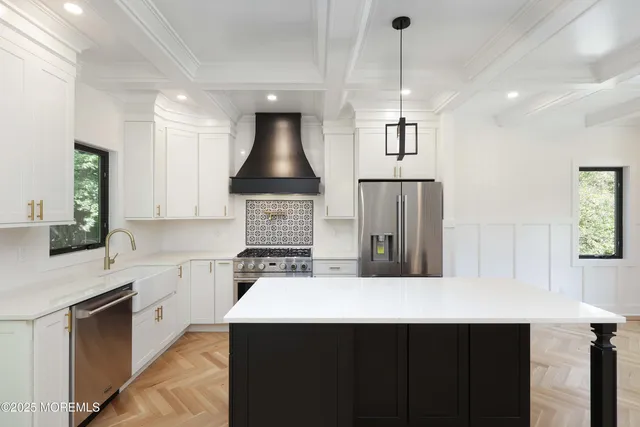 a kitchen with stainless steel appliances a sink stove and refrigerator