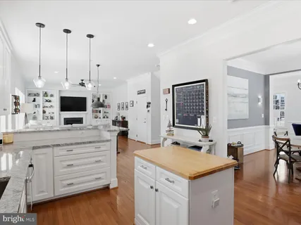 a kitchen with a stove and a wooden floor