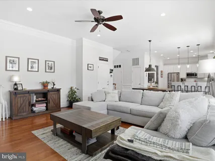 a living room with furniture a rug and a chandelier