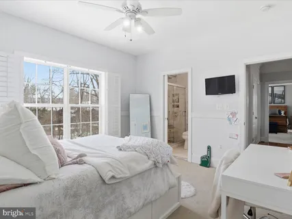 a bedroom with a bed and a large mirror