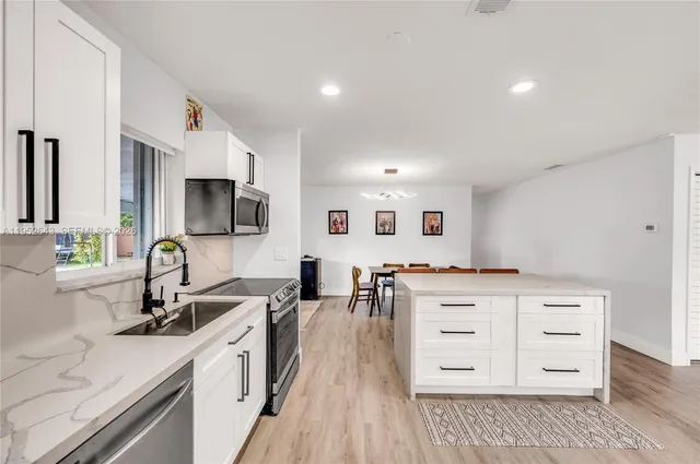 a bathroom with a double vanity sink mirror and toilet