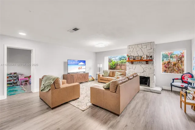 a living room with furniture and a fireplace