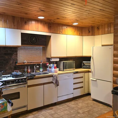 a kitchen with stainless steel appliances a refrigerator and a stove
