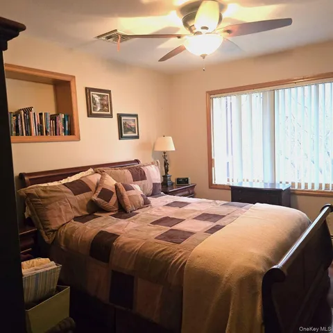 a bedroom with a bed and a window