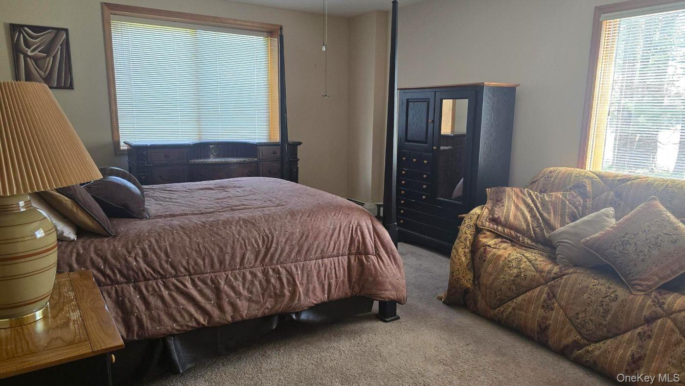 14 Lena Road Monticello, NY 12777 - Photo 23 of 25 a spacious bedroom with a bed couch and window