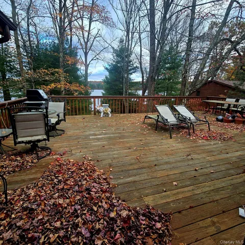 a view of outdoor space with deck and trees
