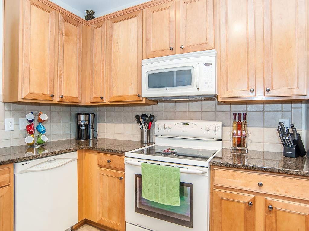 4815 Sir Duncan Way Raleigh, NC 27612 - Photo 12 of 25 Granite countertops and an upgraded Stainless Steel Refrigerator that conveys with the property. Kitchen