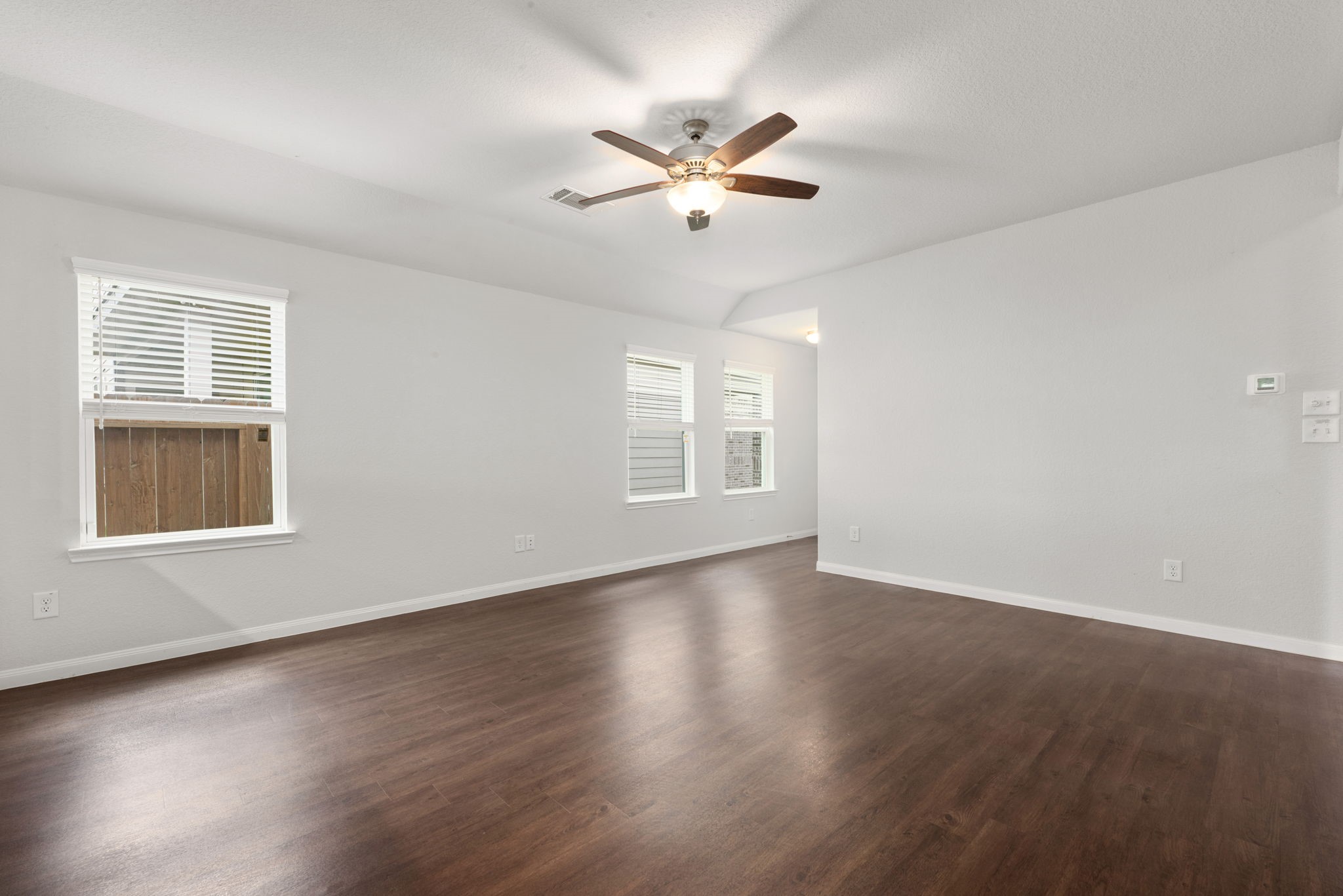 17555 Greystanes Road Humble, TX 77346 - Photo 9 of 28 a view of an empty room with wooden floor and a window