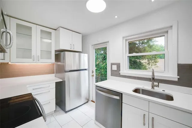 a kitchen with a sink stove and refrigerator