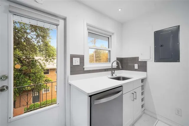 a bathroom with a granite countertop sink and a window