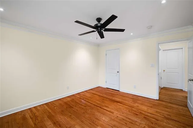 a view of a big room with wooden floor and a ceiling fan