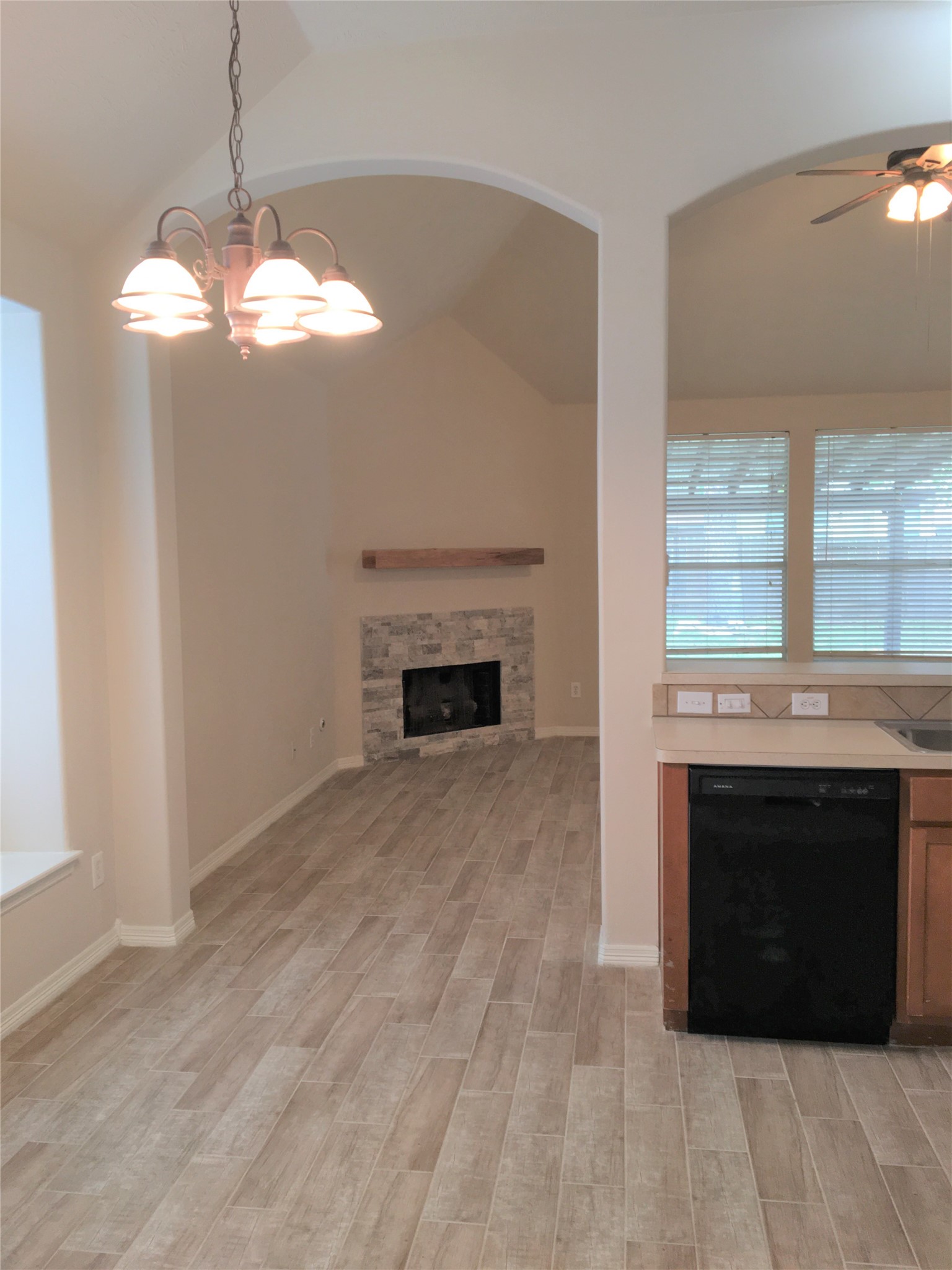 2214 Valley View Crossing Conroe, TX 77304 - Photo 11 of 23 a living room with a fireplace and a chandelier