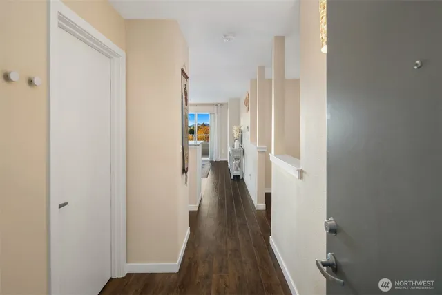 a view of a hallway with wooden floor and staircase
