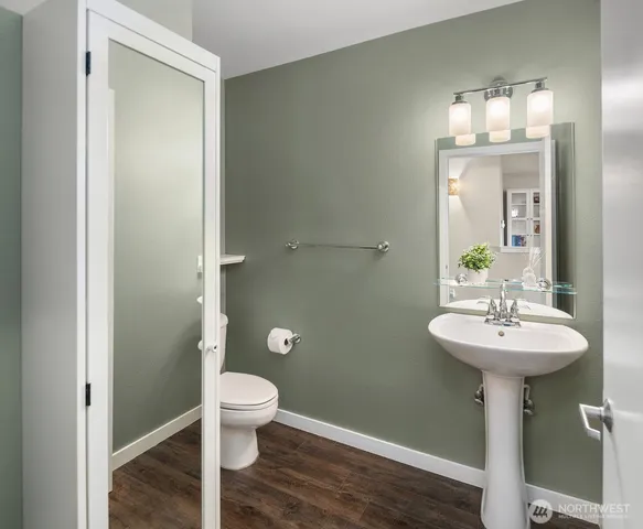 a bathroom with a sink toilet and a mirror
