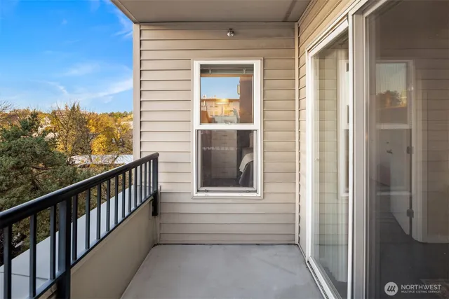 a view of a balcony with a floor to ceiling window and wooden floor