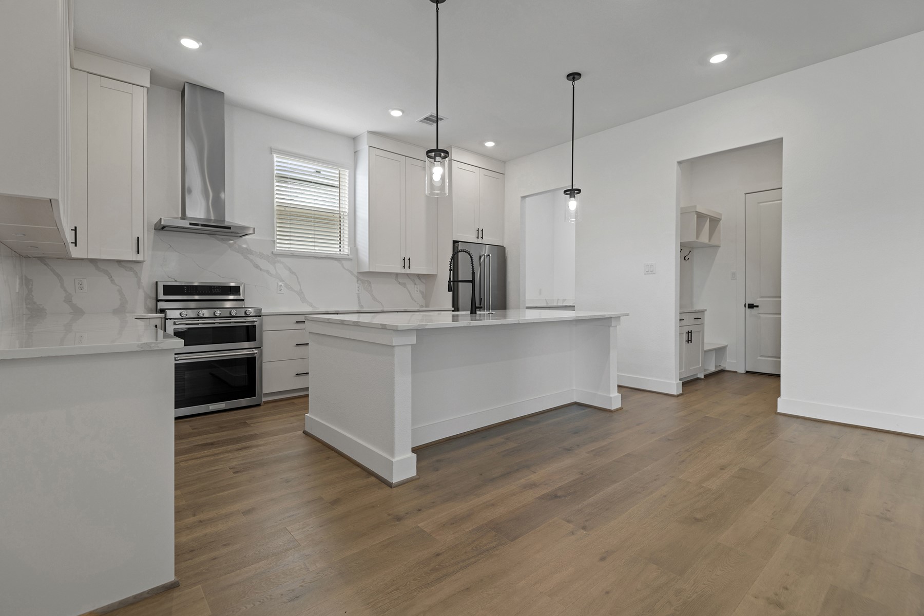 1911 Drover Lane Rosenberg, TX 77471 - Photo 7 of 22 a kitchen with white cabinets and stainless steel appliances