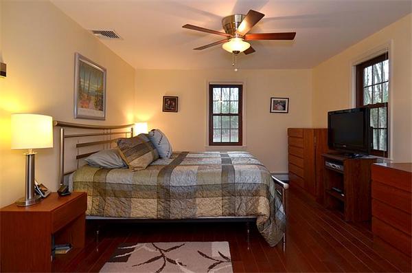 36 Gunnison Road Boxford, MA 01921 - Photo 16 of 24 a bedroom with a bed and a flat screen tv