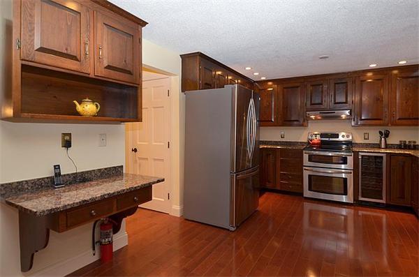 36 Gunnison Road Boxford, MA 01921 - Photo 7 of 24 a kitchen with stainless steel appliances granite countertop a refrigerator stove and microwave