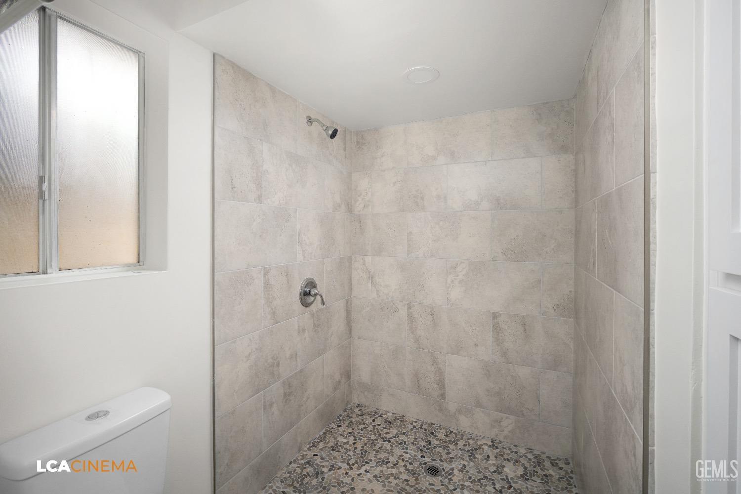 Undisclosed Address Bakersfield, CA 93306 - Photo 15 of 24 a bathroom with a shower and a toilet
