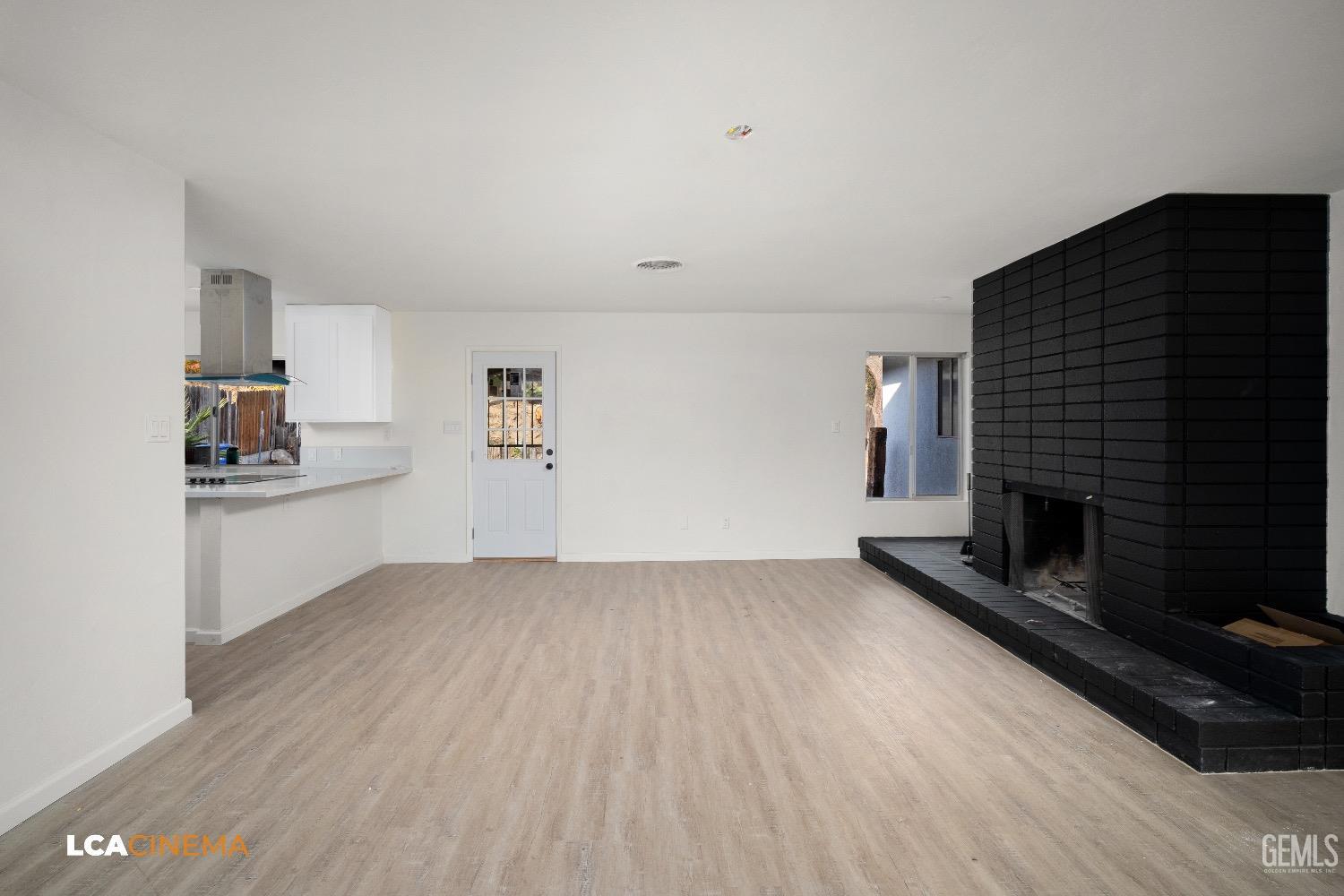 Undisclosed Address Bakersfield, CA 93306 - Photo 19 of 24 a view of empty room with wooden floor and fireplace