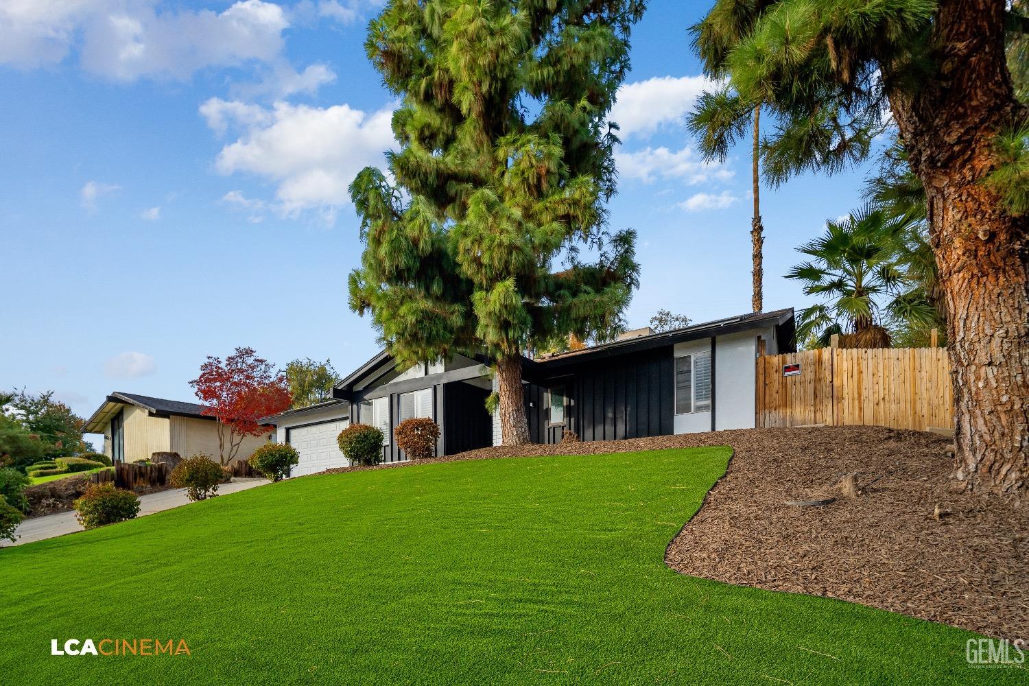 Undisclosed Address Bakersfield, CA 93306 - Photo 4 of 24 a front view of a house with garden
