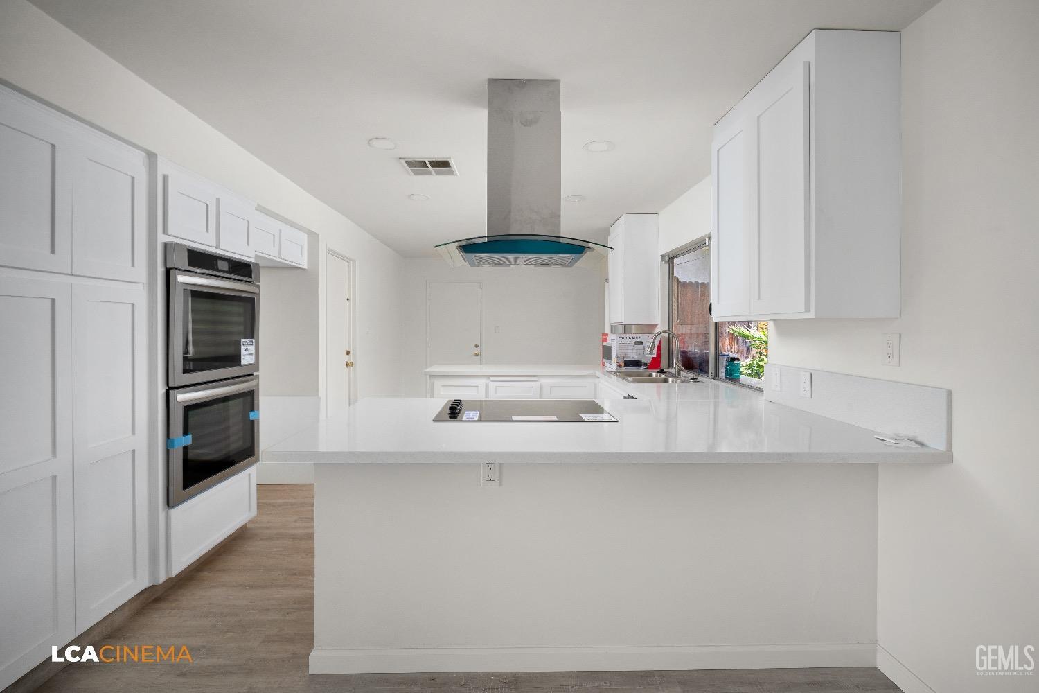 Undisclosed Address Bakersfield, CA 93306 - Photo 8 of 24 a kitchen with stainless steel appliances a sink stove and white cabinets