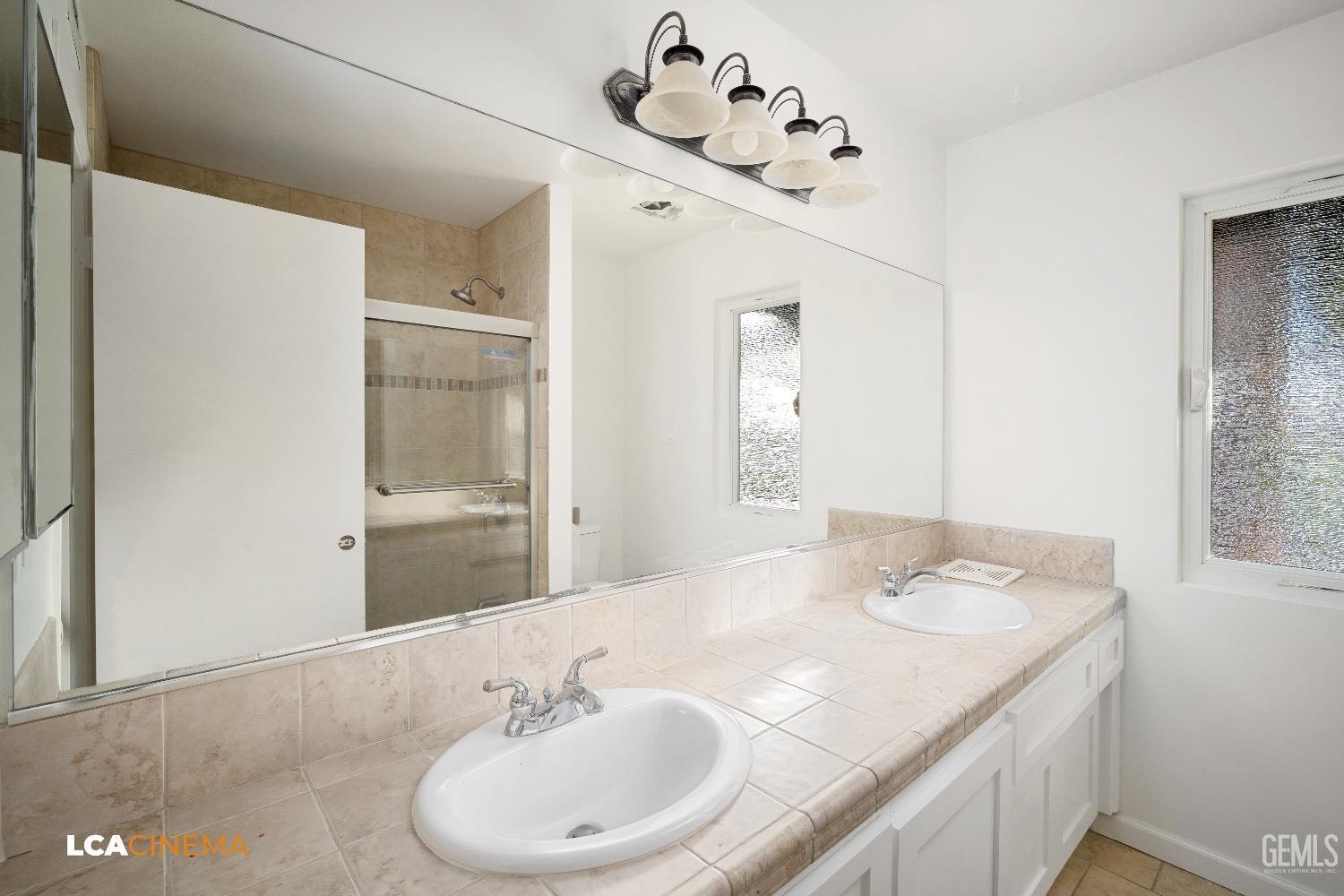 Undisclosed Address Bakersfield, CA 93306 - Photo 10 of 24 a bathroom with a sink and a mirror