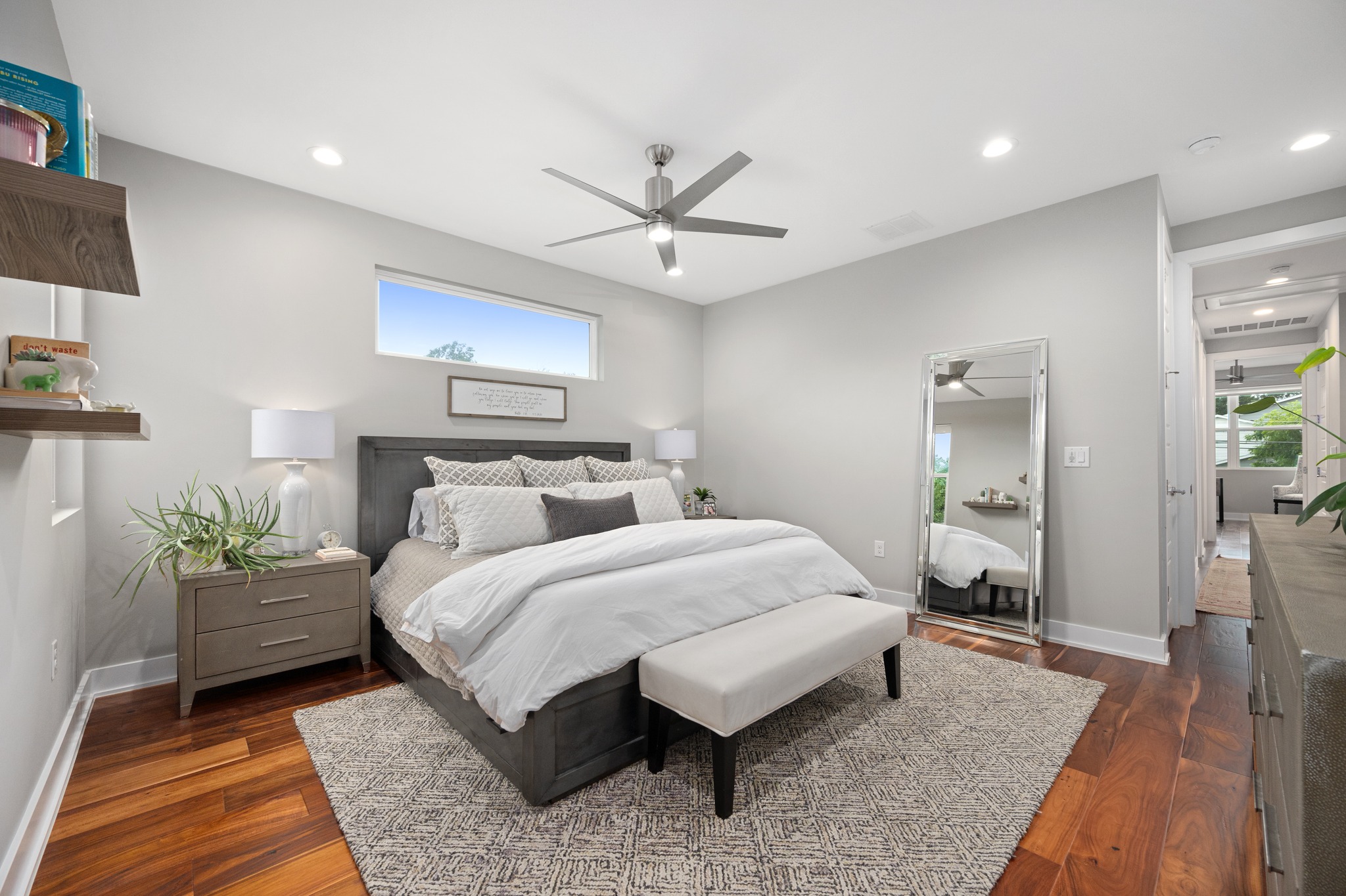 1103 Saucedo Street, Unit 1 Austin, TX 78721 - Photo 29 of 40 Well-lit sleeping quarters with rich hardwood flooring and a stylish ceiling fan.
