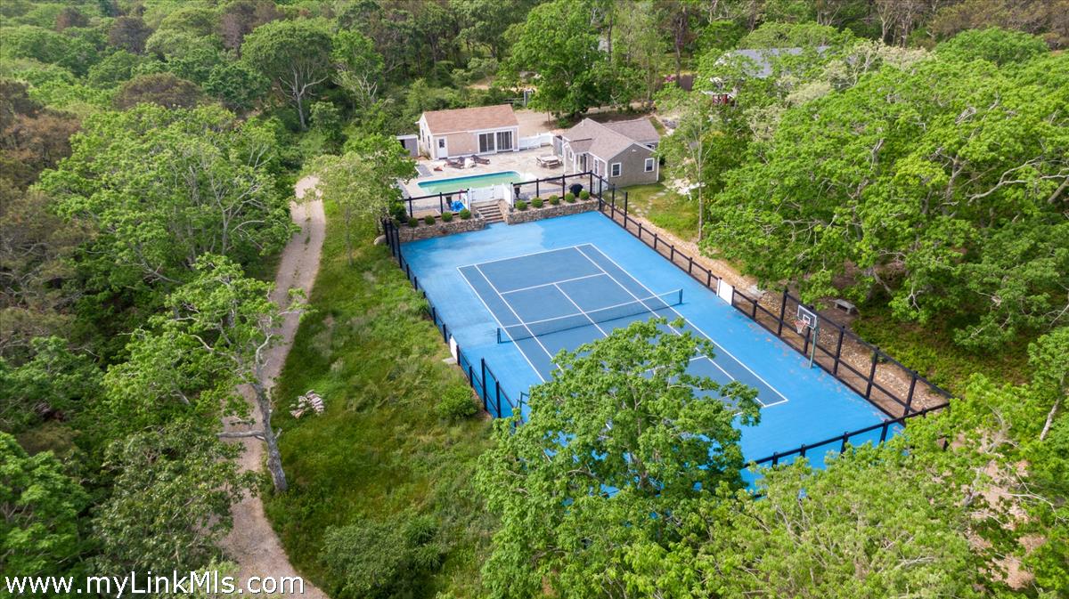 72 Chappaquiddick Avenue Edgartown, MA 02539 - Photo 2 of 63 an aerial view of a house with a yard and trees