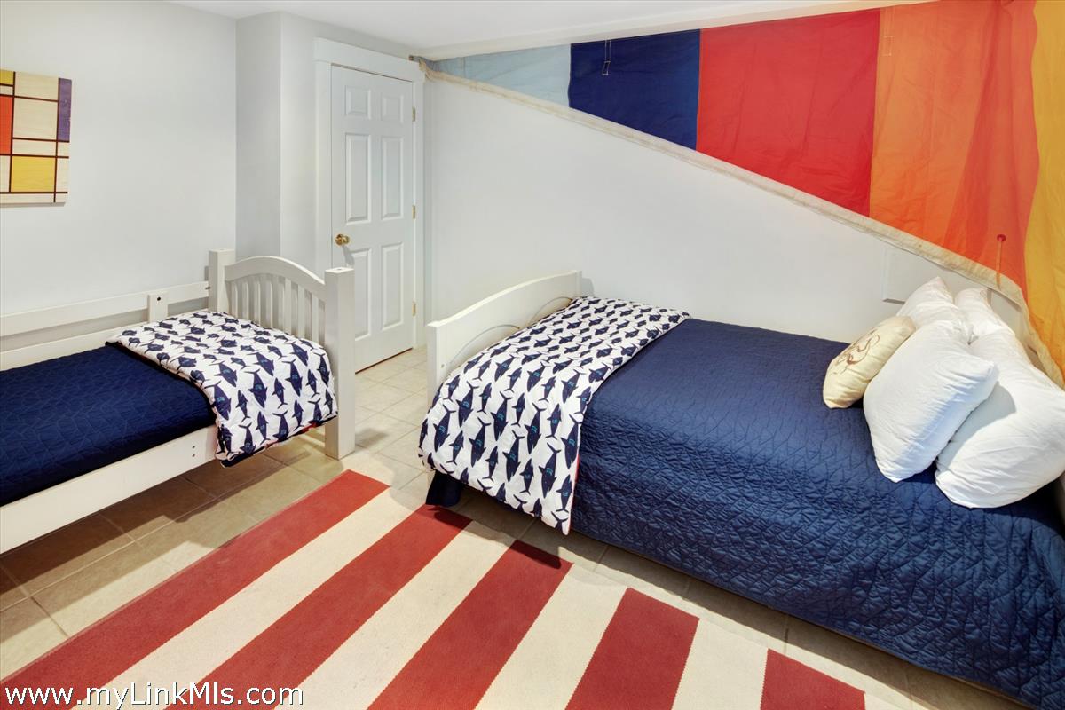 72 Chappaquiddick Avenue Edgartown, MA 02539 - Photo 28 of 63 a bedroom with two beds and a lamp