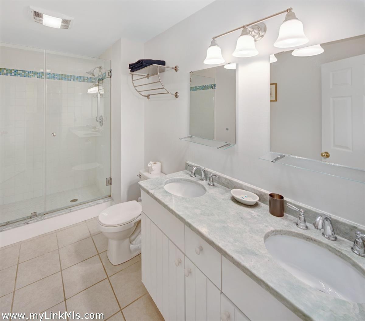 72 Chappaquiddick Avenue Edgartown, MA 02539 - Photo 30 of 63 a bathroom with a granite countertop sink a toilet and a mirror
