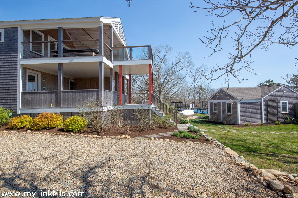72 Chappaquiddick Avenue Edgartown, MA 02539 - Photo 35 of 63 Guest house to the left, fabulous pool house to the right with tennis court in the background