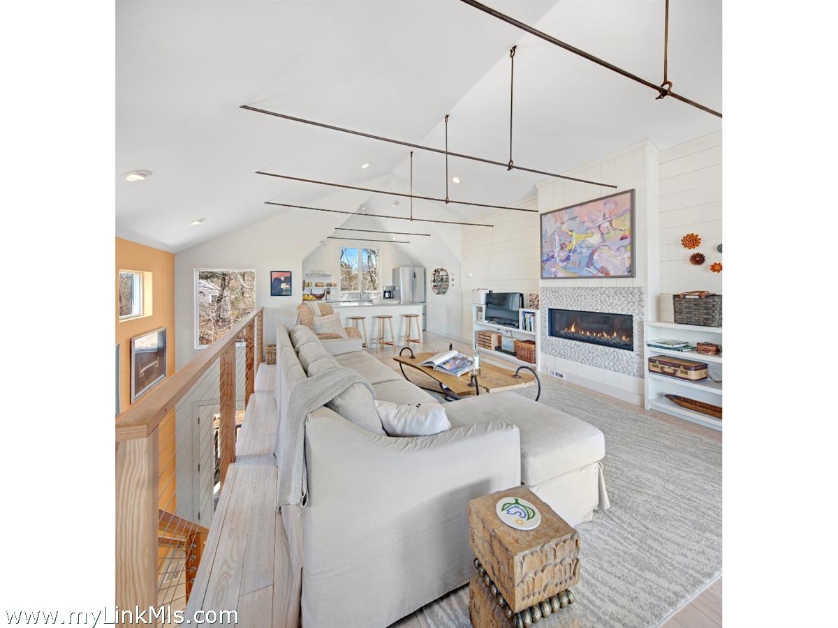 72 Chappaquiddick Avenue Edgartown, MA 02539 - Photo 39 of 63 a living room with furniture and a chandelier